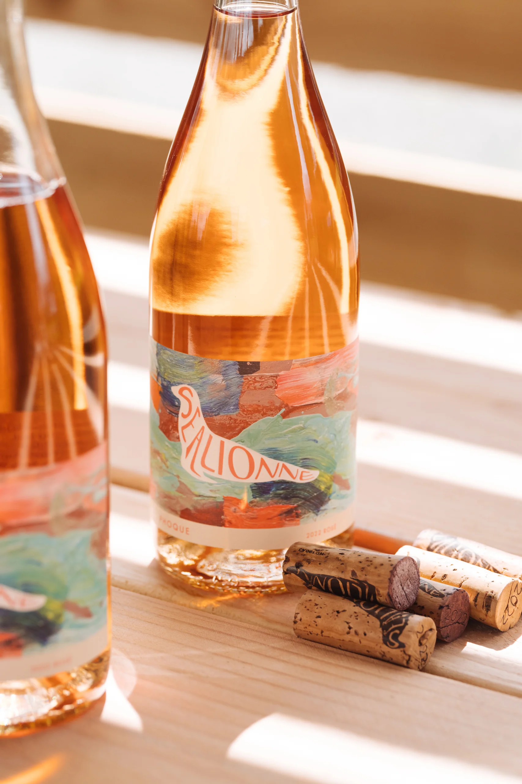 Two Phoque rosé bottles in afternoon sun